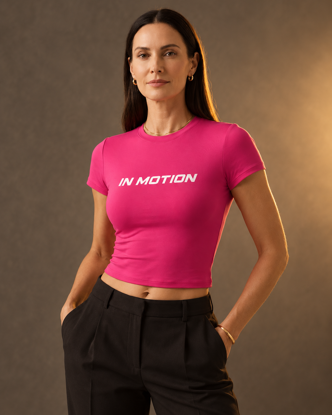 Model wearing pink In Motion fitted crop top
